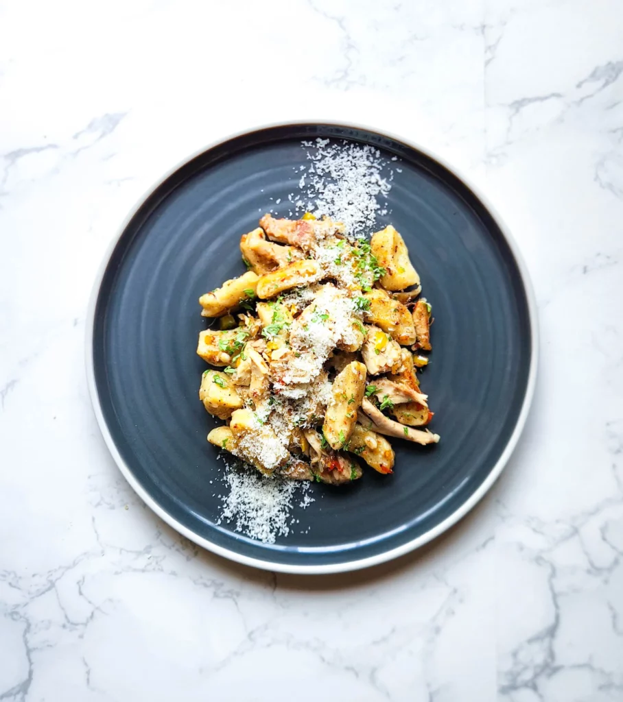 Plate of gnocchi with chicken aglio e olio dressing 