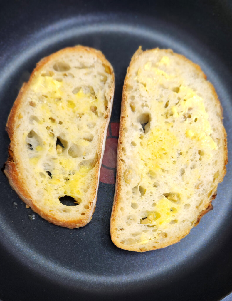 Buttered Sourdough slices toasting in a pan