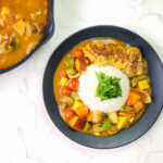 Japanese Curry Rice with potatoes, chicken, carrots and bell peppers in a plate.