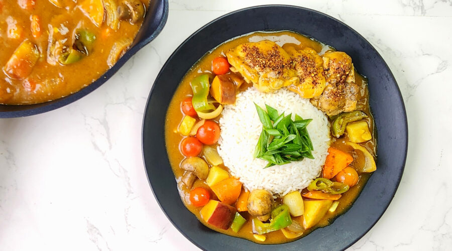 Japanese Curry Rice with potatoes, chicken, carrots and bell peppers in a plate.