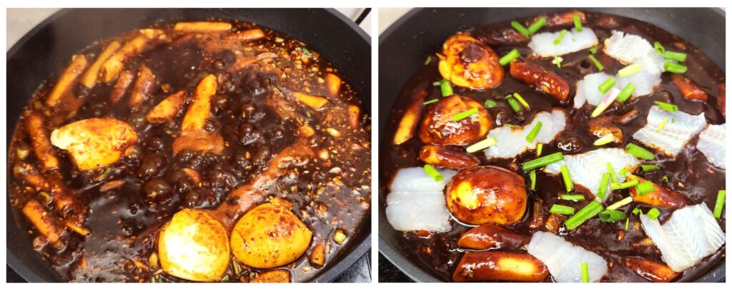 Tteokbokki in a pan, sauce bubbling with fish, hardboiled eggs and green onions. 