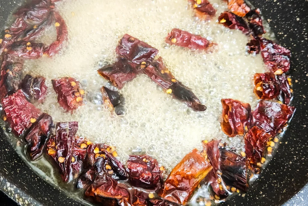 Indonesian sambal terasi dry red chilli boiling in water