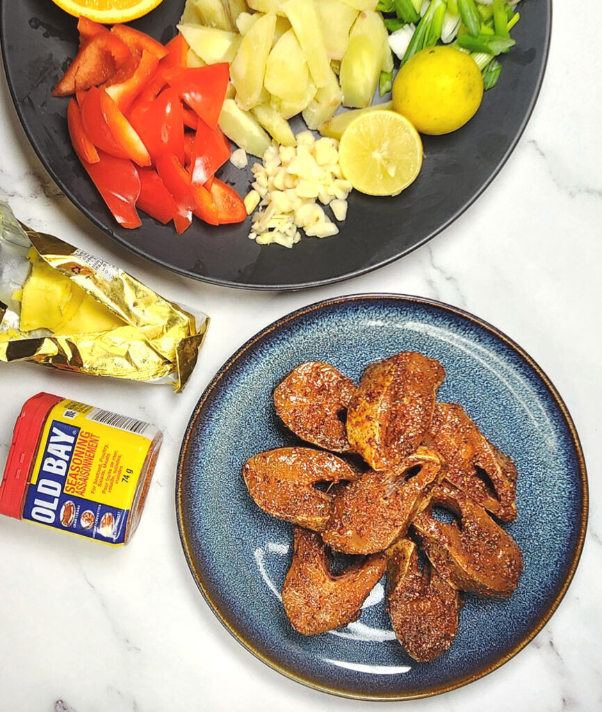 Cajun style blackened fish fillets marinated in cajun seasoning, sweet potato hash ingredients with bell peppers, spring onions, garlic and limes and oranges