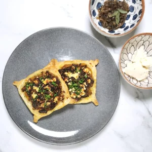 Caramelised onion galette pastry with roasted pumpkin and goat's cheese on a plate