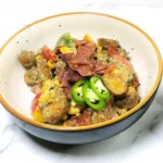 Japanese-fusion potato salad with bacon, vegetables and mustard, mayonnaise dressing in a bowl. baby potatoes, parsley and honey.