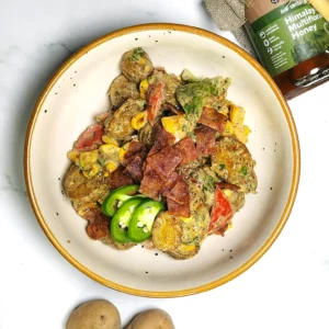 Japanese-fusion potato salad with bacon, vegetables and mustard, mayonnaise dressing in a bowl. baby potatoes, parsley and honey.