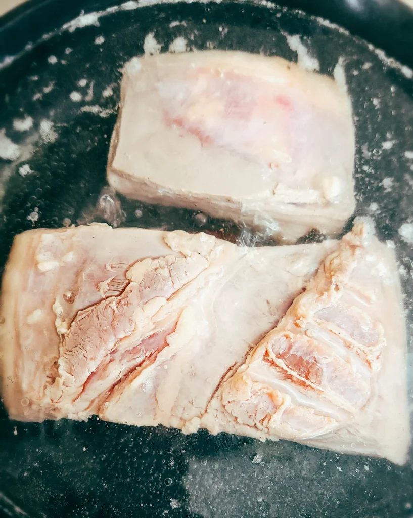 Chinese crispy pork belly boiling