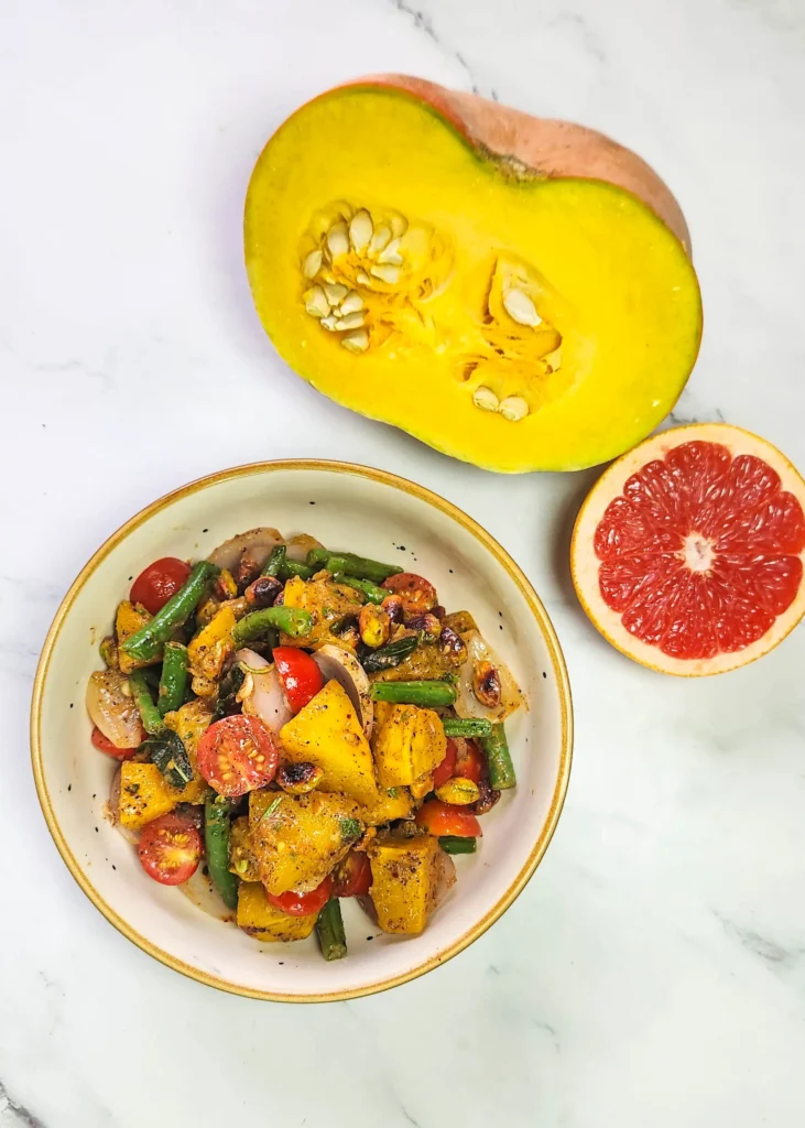 Roasted pumpkin salad in a lunchbox with cherry tomatoes, pistachios, beans, onions, pumpkin, butter, garlic and sage leaves. Sumac, mustard sauce, lime, honey and grapefruit dressing. Grilled prawns and lime.