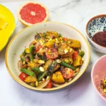 Roasted pumpkin salad in a lunchbox with cherry tomatoes, pistachios, beans, onions, pumpkin, butter, garlic and sage leaves. Sumac, mustard sauce, lime, honey and grapefruit dressing. Grilled prawns and lime.