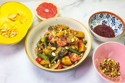 Roasted pumpkin salad in a lunchbox with cherry tomatoes, pistachios, beans, onions, pumpkin, butter, garlic and sage leaves. Sumac, mustard sauce, lime, honey and grapefruit dressing. Grilled prawns and lime.