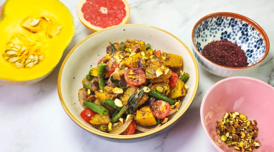 Roasted pumpkin salad in a lunchbox with cherry tomatoes, pistachios, beans, onions, pumpkin, butter, garlic and sage leaves. Sumac, mustard sauce, lime, honey and grapefruit dressing. Grilled prawns and lime.