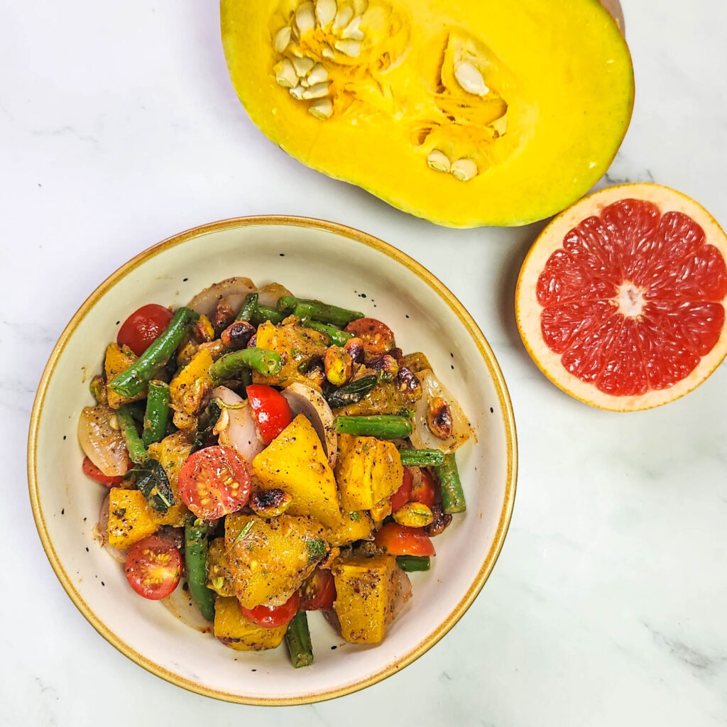 Roasted pumpkin salad in a lunchbox with cherry tomatoes, pistachios, beans, onions, pumpkin, butter, garlic and sage leaves. Sumac, mustard sauce, lime, honey and grapefruit dressing. Grilled prawns and lime.