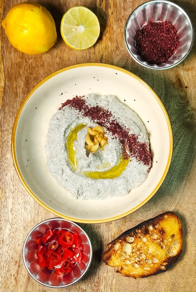 Black Sesame Labneh Dip Recipe final photo with confit garlic, toast, sumac, lemon and pickled peppers